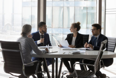 Busy millennial professional group reviewing startup marketing reports