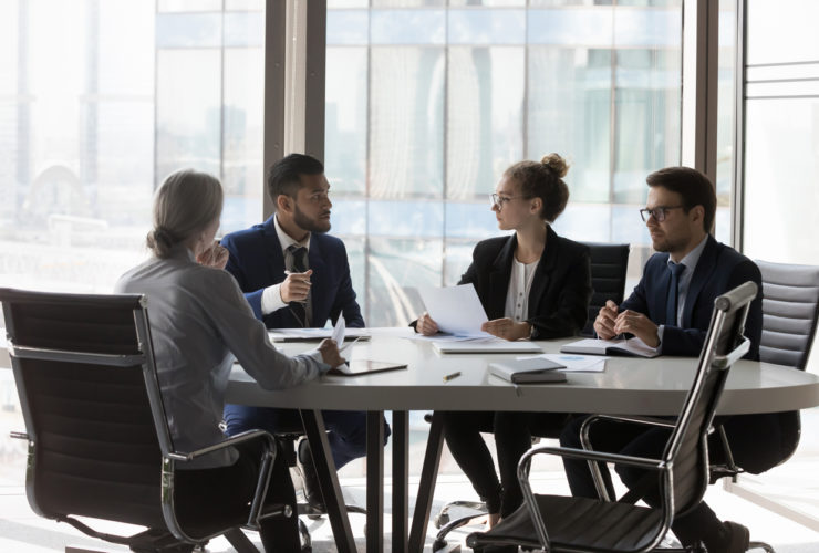 Busy millennial professional group reviewing startup marketing reports