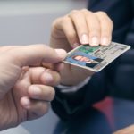 mężczyzna skanuje dowód osobisty smartfonem na biurku w nowoczesnym biurze