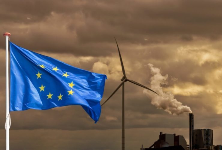 Waving,European,Flag,In,Front,Of,A,Polluting,Factory,Chimney