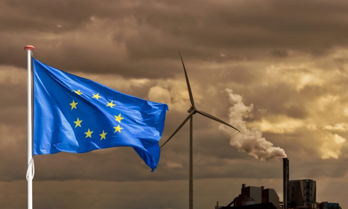 Waving,European,Flag,In,Front,Of,A,Polluting,Factory,Chimney
